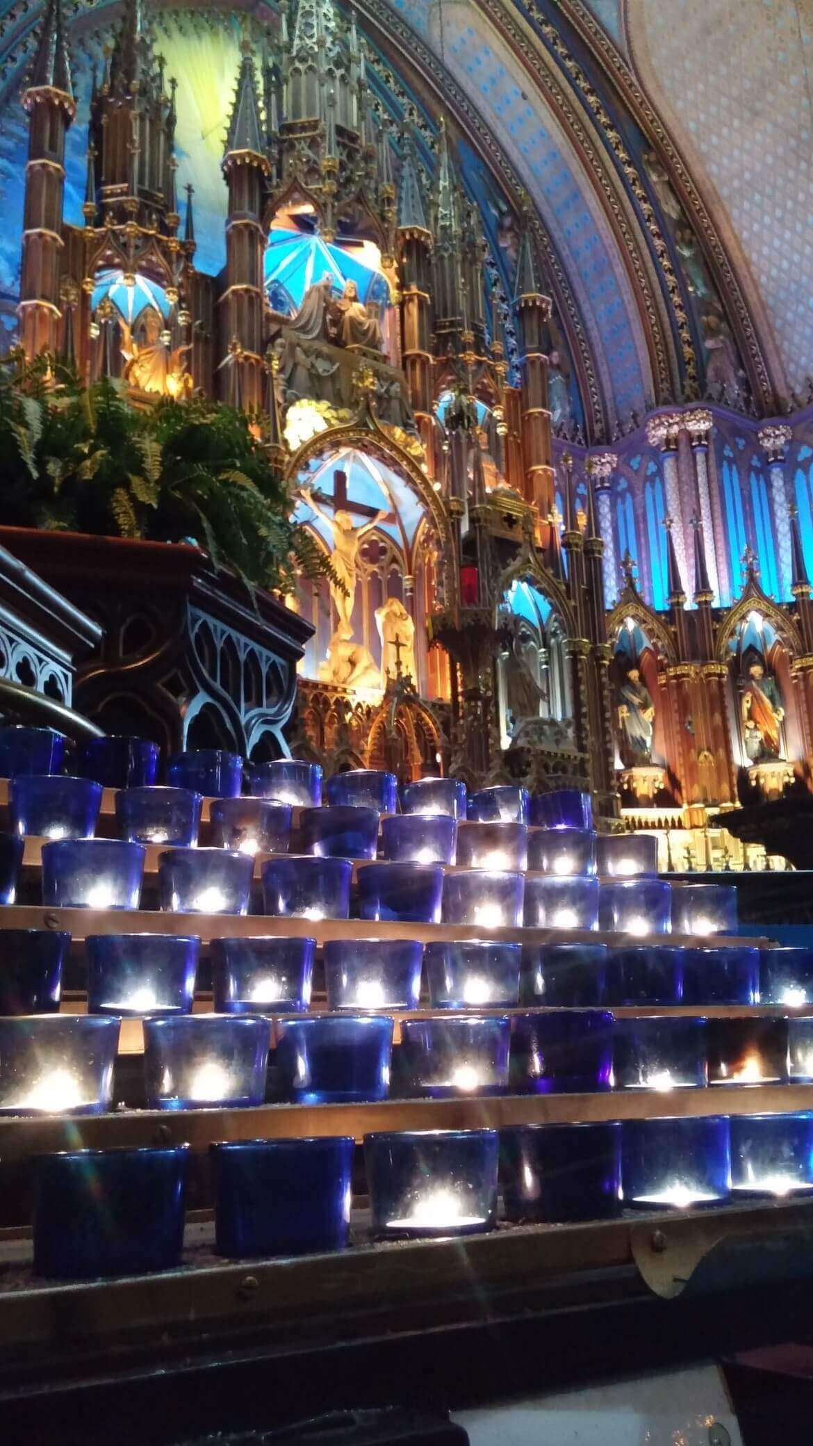 Blue and other colored candles are everywhere inside the cathedral